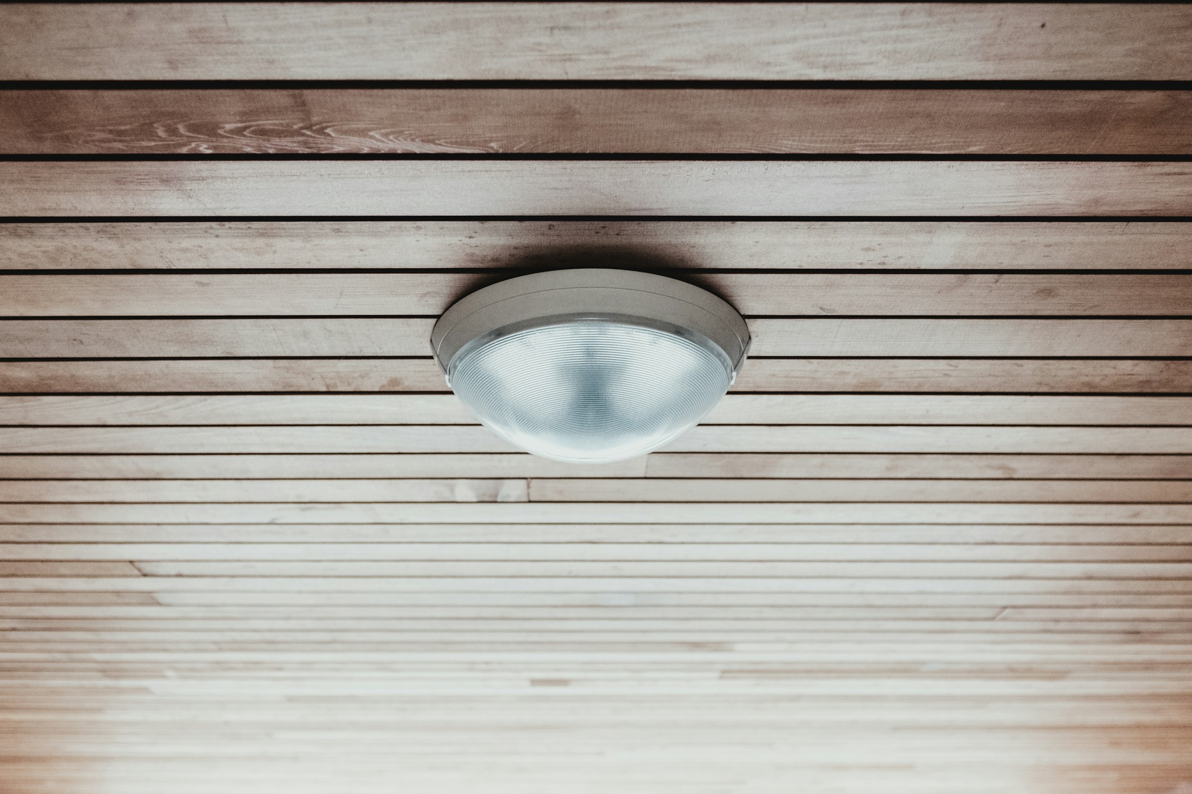 Ceiling-mounted detector on a timber-lined ceiling