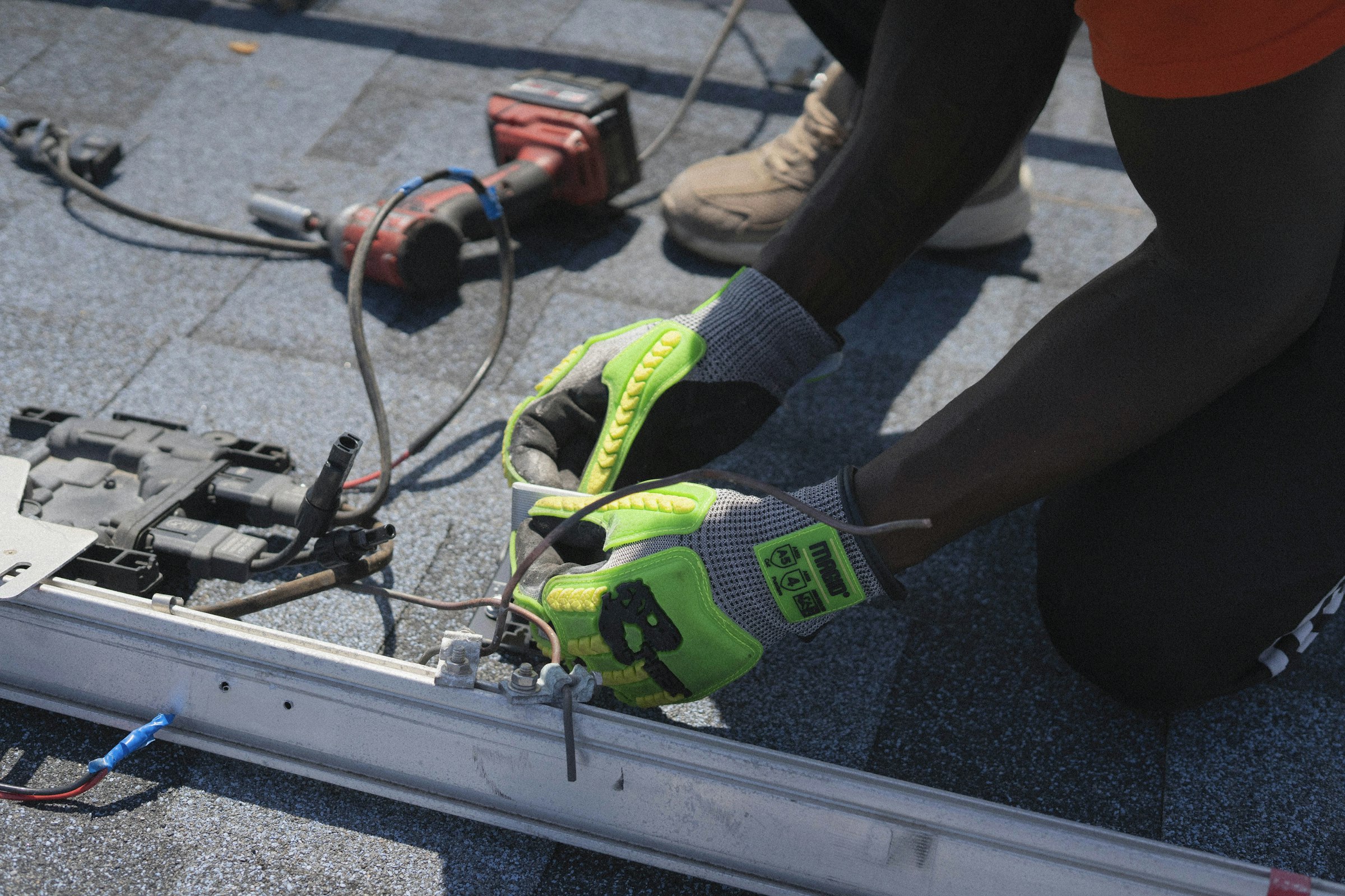 Gloved hands wiring electrical components on site